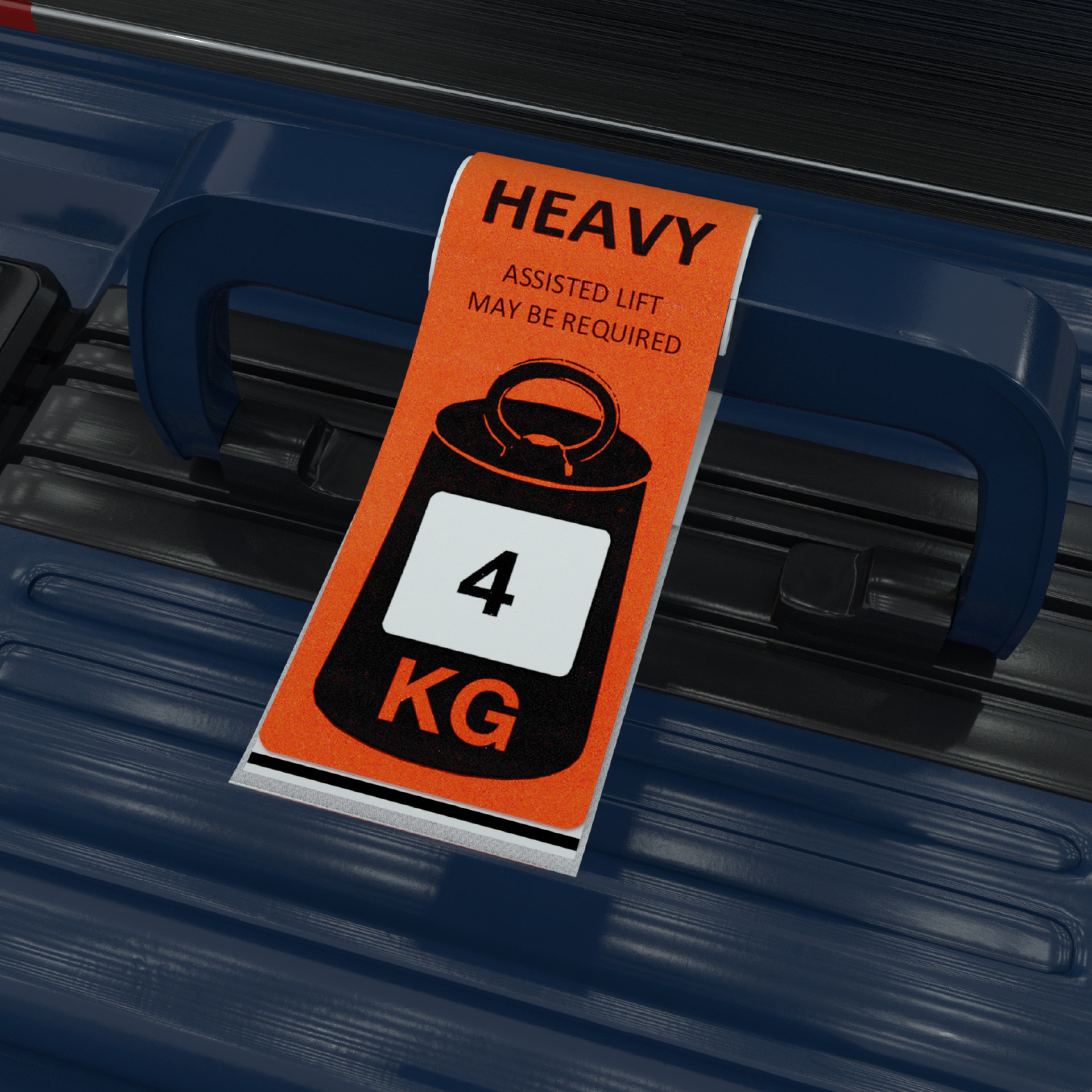 Orange heavy luggage tag attached to a blue suitcase handle, reading "Heavy – Assisted lift may be required" with a weight icon showing 4 KG.