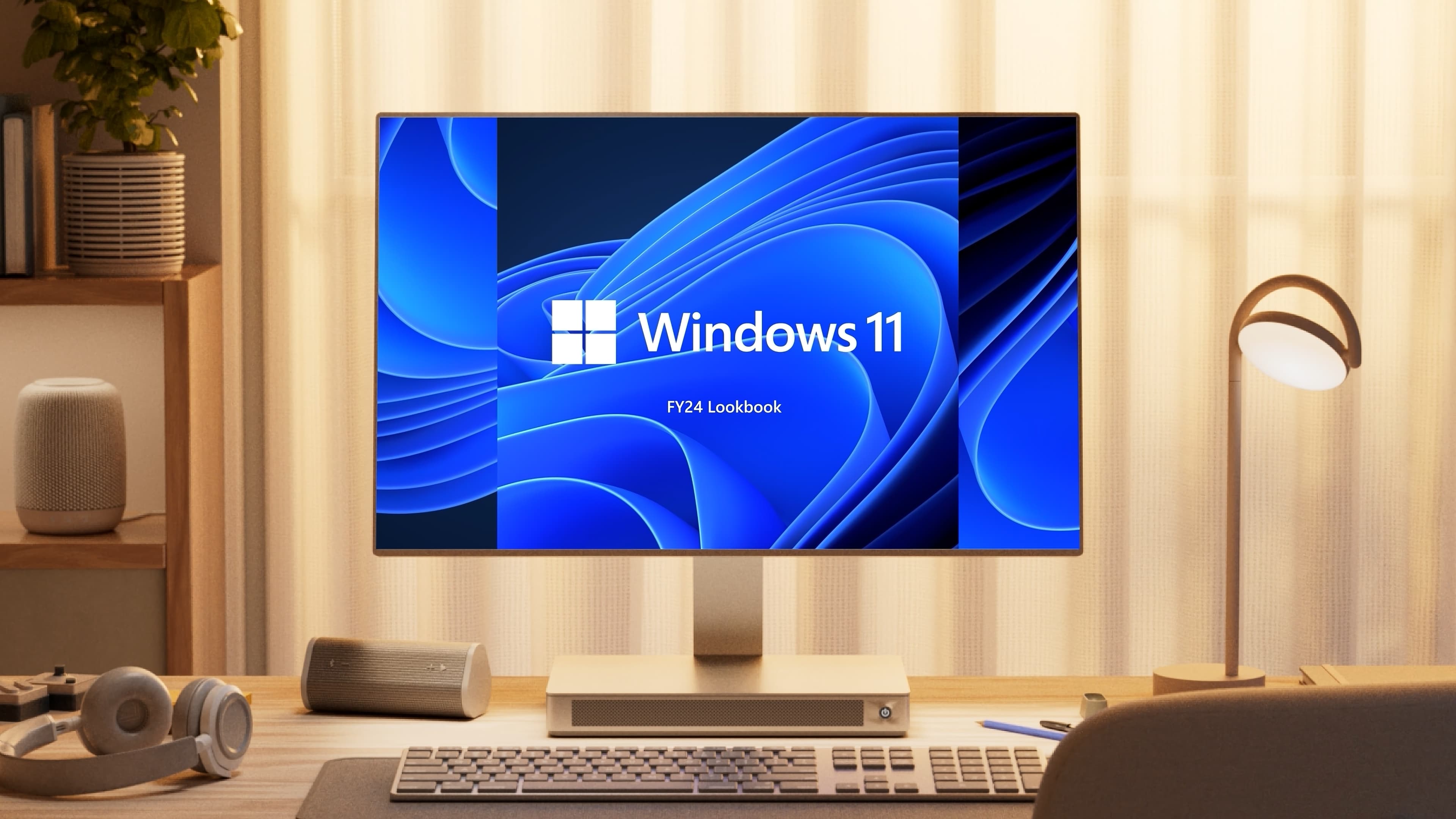 "Windows 11 FY24 Lookbook title screen displayed on a monitor at a modern home desk setup."