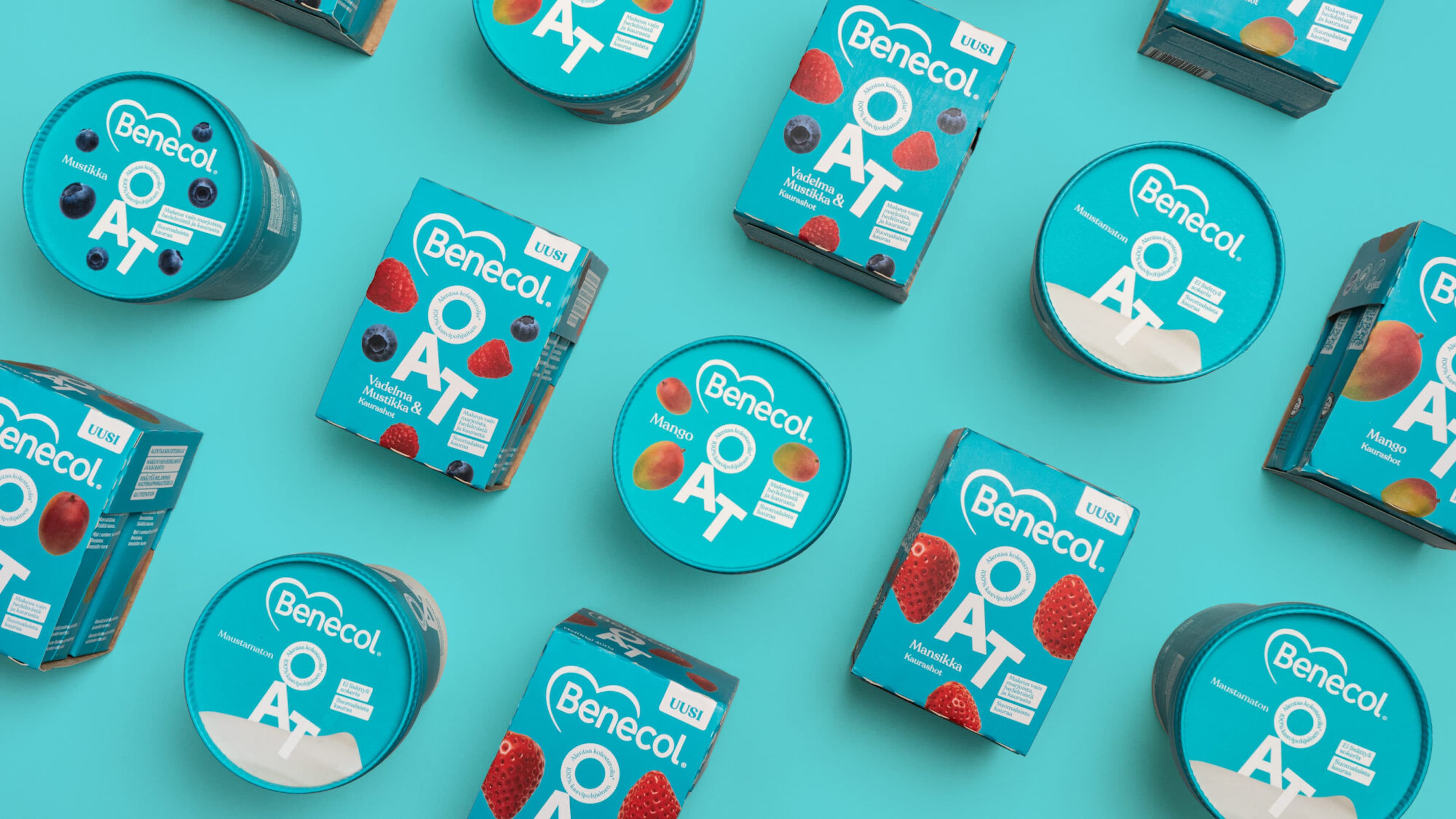 Assorted Benecol OAT oat-based product cups and multipack boxes in flavors including Mango, Strawberry (Mansikka), Raspberry-Blueberry (Vadelma Mustikka), and plain (Maustamaton), arranged on a teal background.