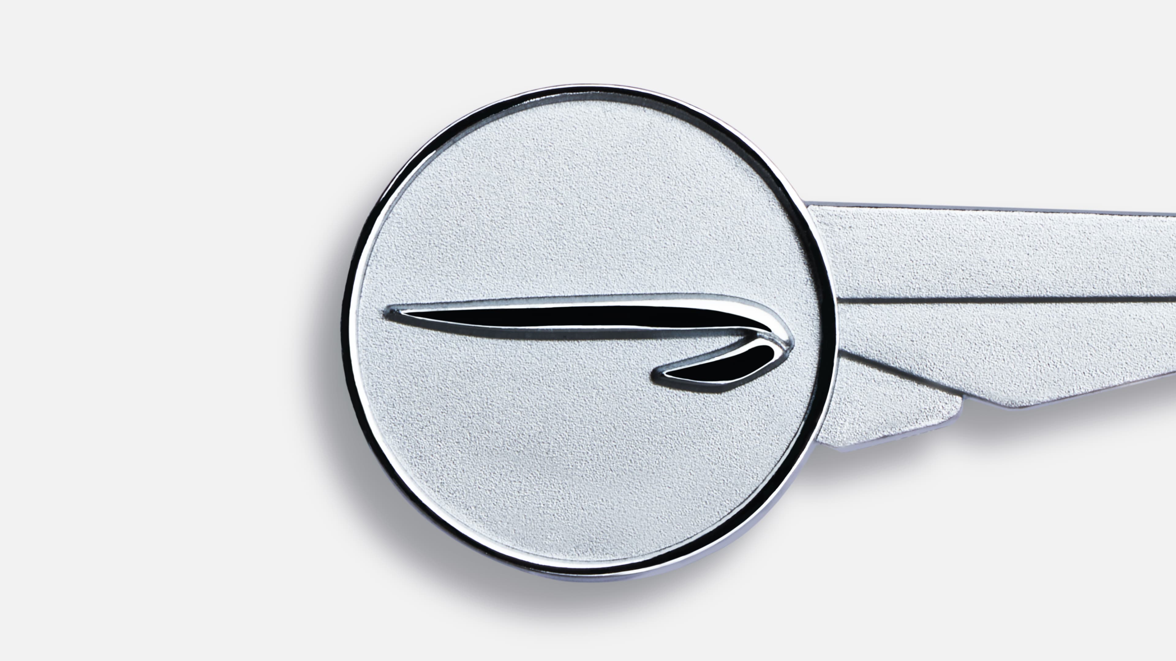 Chrysler "Forward Look" speedmarque badge: a chrome circular emblem with a stylized swept wing, shown with an extended wing detail to the right.